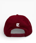 Crimson cap with a white logo on a light gray background
