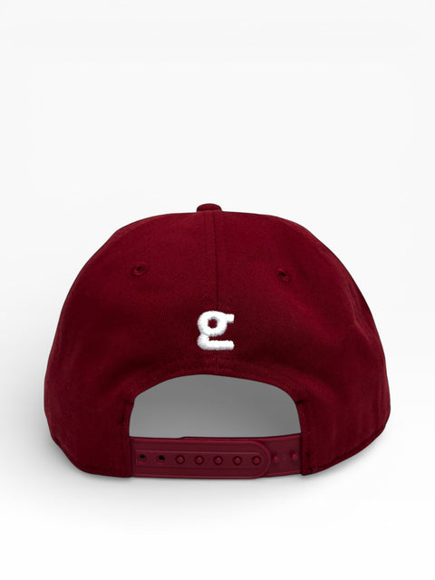 Crimson cap with a white logo on a light gray background